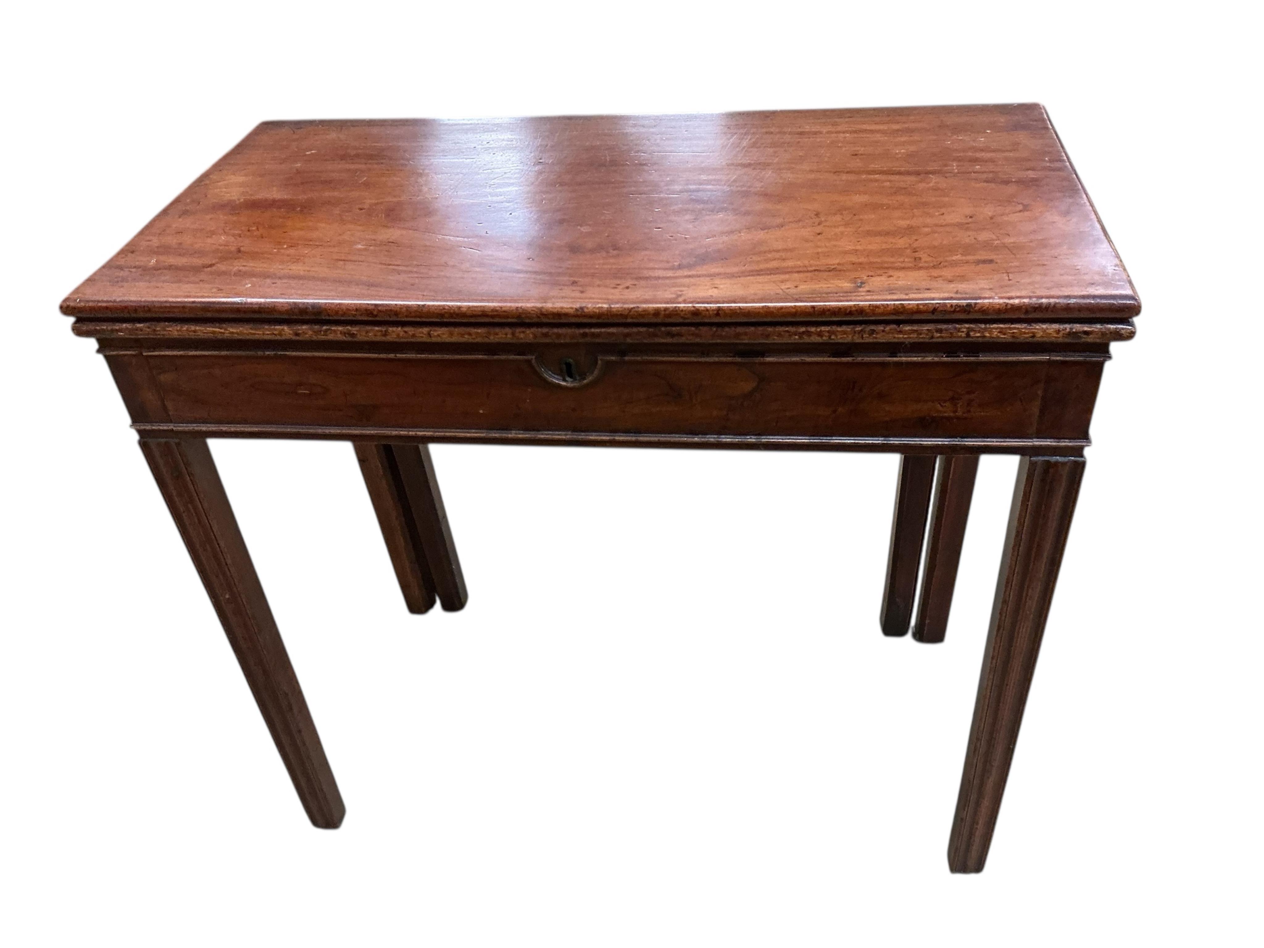 A George III rectangular mahogany and elm folding card table, width 84cm, depth 41cm, height 75cm